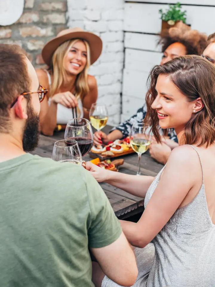 Group of people enjoying hors d'oeuvres and wine outdoor daytime | Salt Lake City Apartments